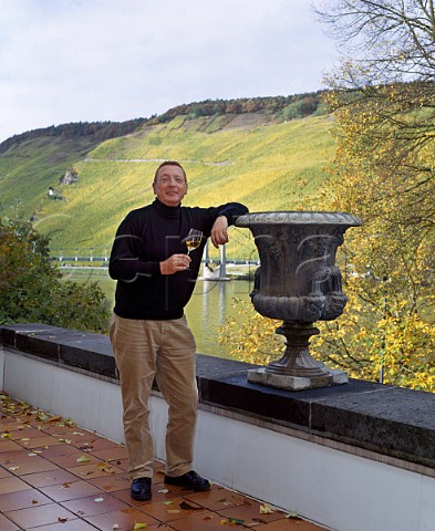 Raimund Prm winemaker  owner of Weingut SAPrm with the Mosel river and Wehlener Sonnenuhr vineyard   behind Wehlen Germany    Mosel