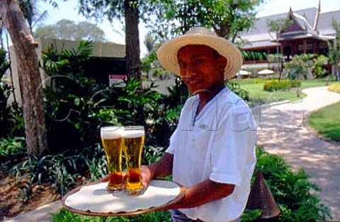Waiter serving beer at the Hyatt Regency   resort Hua Hin Thailand