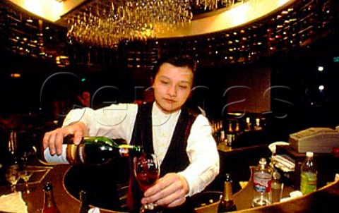 Barman pouring wine in trendy wine bar   Shanghai China