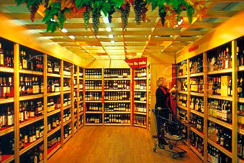 Customer in the wine department of a   French supermarket