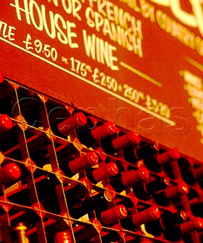 Wine rack and price list behind the counter of a   London wine bar
