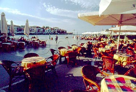 Caf tables by the harbour Hania    Crete Greece