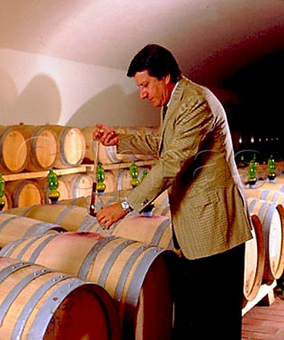 Franco Bernabei consultant winemaker taking a   sample from barrel in the chai of   Il Molino di Grace Panzano in Chianti Tuscany   Italy  Chianti Classico