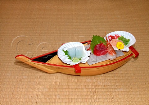 Japanese sashimi displayed on a wooden boat