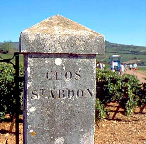 Entrance pillar to the Clos StAbdon vineyard of   ColinDeleger with pickers beyond    ChassagneMontrachet Cte dOr France