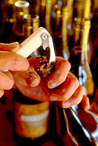Opening bottle of wine with a Waiters   Friend corkscrew