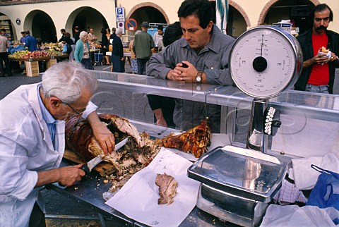 Selling porchetta roast suckling pig   at a market stall Greve in Chianti   Tuscany Italy