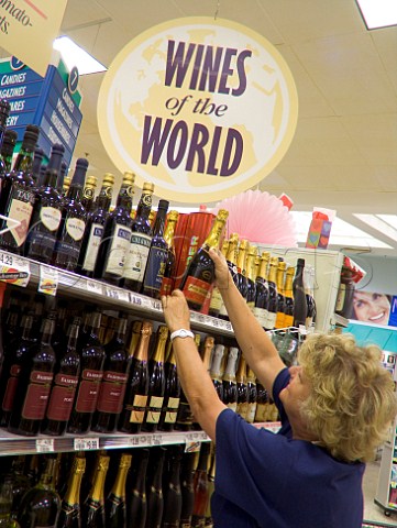 Female shopper in supermarket wine section    Florida USA