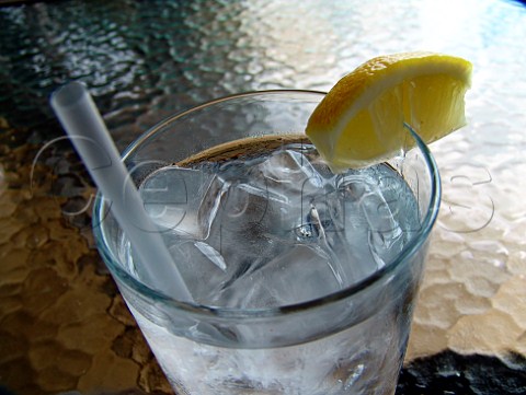 Glass of iced water with straw  slice of lemon