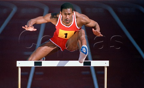 Runner jumping over hurdle