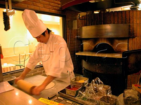 Chef rolling out pizza dough in an Italian style    restaurant  Tokyo  Japan
