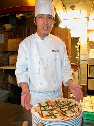 Chef with an aubergine pizza in an Italian style   restaurant  Japan