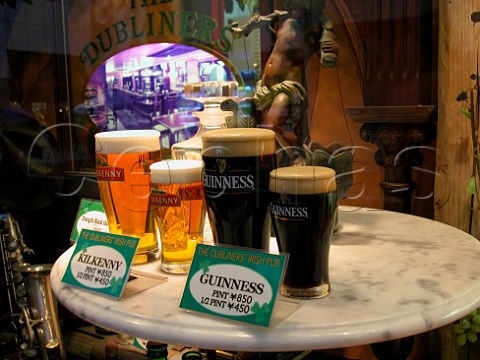 Plastic models of beer in a window display outside   an Irish pub in the Shinjuku district of Tokyo Japan