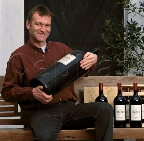 Josef Umathum with bottles of his Frauenkirchner wine Frauenkirchen Burgenland Austria Neusiedlersee