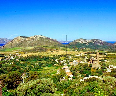 View over the village and church of Patrimonio with   the Golfe de StFlorent visible between the hills   HauteCorse Corsica France   AC Patrimonio