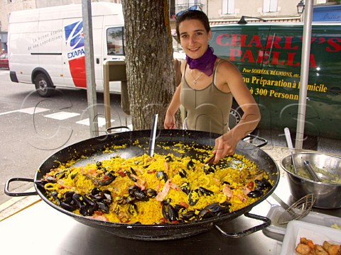 Preparing paella in a giant frying pan at Blaye  market Gironde France Aquitaine