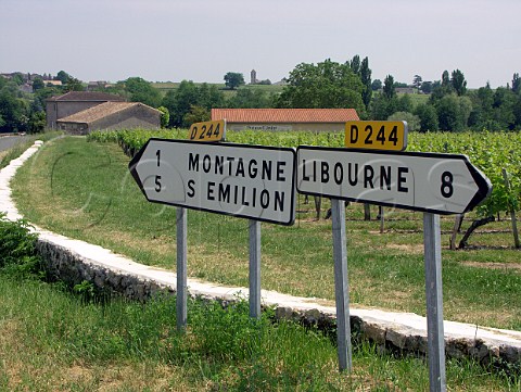 Road signs near Montagne village with StGeorges   village church behind  Gironde France   StGeorgesStmilion  Bordeaux