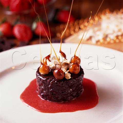 Ganache Cake made by Francesco Roccato hazelnuts   torrone nougat and chocolate with strawberry sauce  Piemonte Italy
