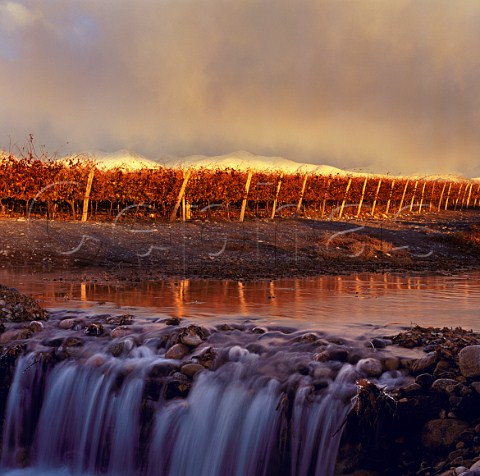 Irrigation channel in Adrianna vineyard of Catena   Zapata at an altitude of around 1500 metres with the   Andes beyond Gualtallary Mendoza Argentina     Tupungato