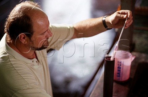 The late Anton Bredell measuring specific gravity of fermenting must  Bredell winery Somerset West South Africa  Stellenbosch