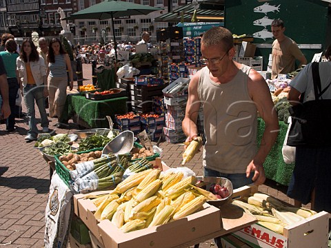 Displaying sweet corn on a fruit and vegetable stall   in Kingston market Kingston upon Thames Surrey