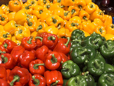 Display of red yellow and green bell peppers on a market stall KingstonuponThames Surrey