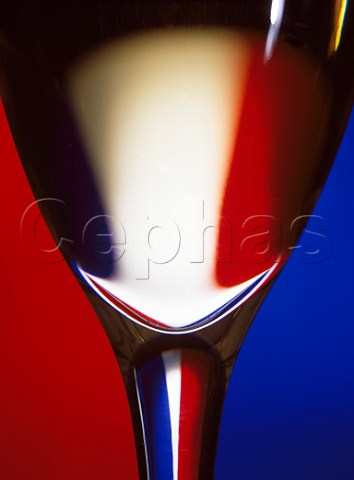Glass of white wine with the French tricolore behind
