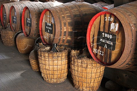 Barrels of Madeira wine maturing by the naturalCanteiro process and showing the European seals onthe front in a loft of the Old Blandy Wine LodgeArcadas de So Francisco part of the Madeira WineCompany Funchal Madeira Portugal