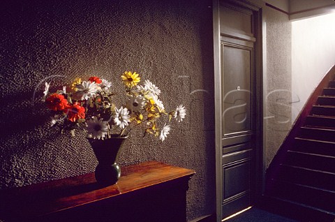 Vase of flowers on sideboard in hall of   Montmartre hotel Paris France
