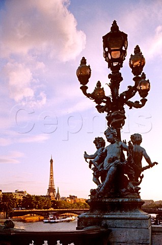 Ornate street lamps on Pont Alexandre III bridge  with Eiffel Tower in background Paris France