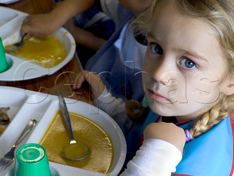 Solemn kindergarten girl leaves her school meal  uneaten