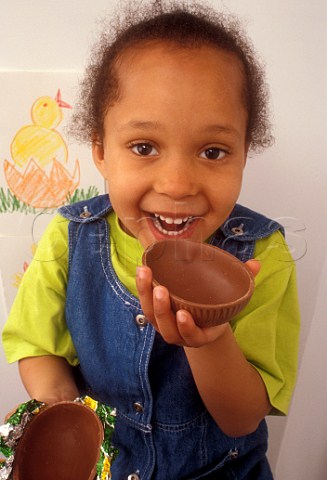 Easter Four year old afrocaribbean girl enjoys her  chocolate egg
