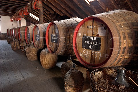 Barrels of Madeira wine maturing by the naturalCanteiro process and showing the European seals onthe front in a loft of the Old Blandy Wine LodgeArcadas de So Francisco part of the Madeira WineCompany Funchal Madeira Portugal