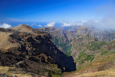Mountainous landscape at Pico do Arieiro with the   Atlantic Ocean in the distance Madeira Portugal