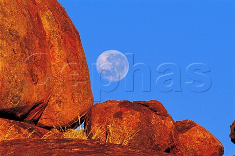 Full moon at sunrise at the Devils Marbles Northern   Territory Australia