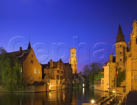 Octagonal Belfry tower and canal at dusk Brugge   Belgium