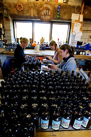 Hand labelling of bottles at the Somerset Cider   Brandy Company    Kingsbury Episcopi Somerset   England