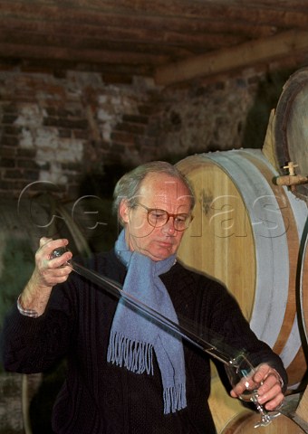 Etienne Dupont taking sample of Calvados from barrel in cellar of Domaine Dupont  VictotPontfol Calvados France  Normandy