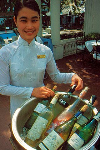 Wine waitress with a selection of chilled wine at the  Metropole hotel Hanoi Vietnam