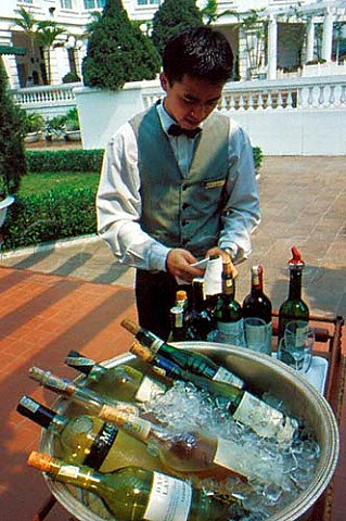 Wine waiter with a selection of wines at the Metropole  hotel Hanoi Vietnam