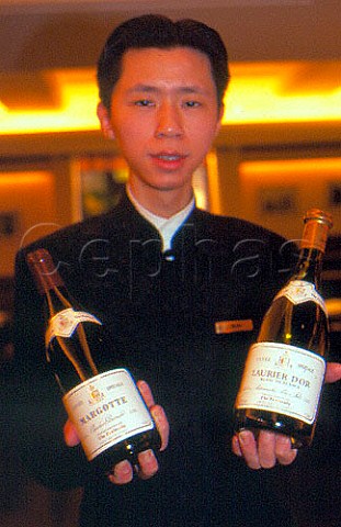 Waiter with bottles of house wine at   Peninsula Hotel Hong Kong