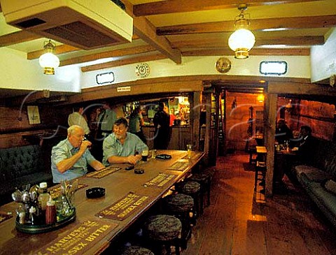 Interior of the Tollesbury originally built as a Thames barge now permanently moored in Millwall Inner Dock in Londons Docklands after being converted into a pub  It is one of the many barges that were used in the Dunkirk evacuation of 1940
