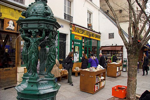 Wallace drinking fountain dating from 1840 in front   of the Shakespeare and Company bookshop Paris   France