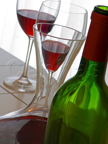 Glasses of red wine with bottle and decanter