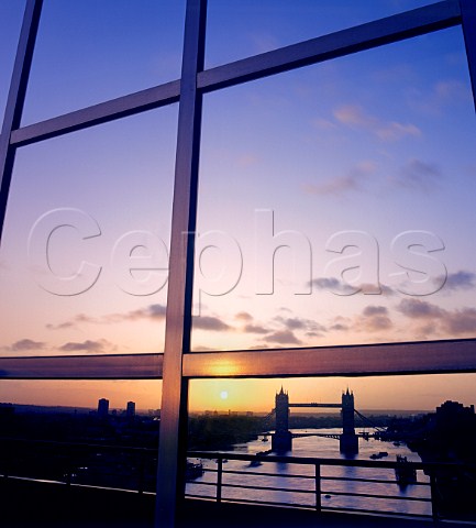 Tower Bridge and the River Thames reflected in   modern office glass windows at sunrise City of London   UK