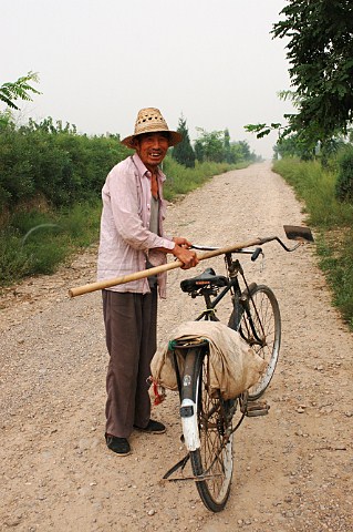 Grace Vineyard worker with bicycle     Near Taiyun   Shanxi province China   Yellow River region