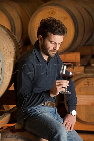 Silvano Boroli with glass of Villero Barolo in   cellar of Vini Boroli Madonna di Como near Alba   Piemonte Italy