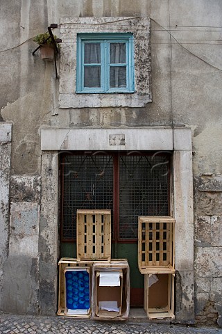 Boxes stacked in a doorway Alfama Old Lisbon   Portugal