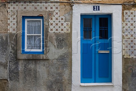Remains of traditional azulejos tiles surrounding   window and doorway  Alfama Old Lisbon Portugal