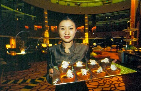Waitress with tray of desserts in hotel   restaurant  Shanghai China